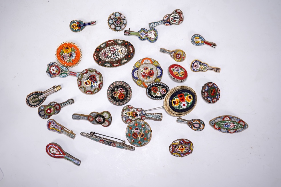 A collection of twenty-eight brooches, including fourteen mixed guitar and banjo shaped brooches, six large oval brooches, seven smaller brooches and one small oval., Condition - good